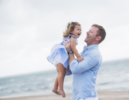 Father holding daughter