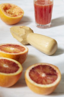 Sliced grapefruit with juicer