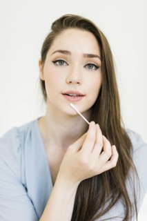 Woman holding cotton bud