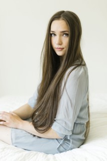 Portrait of young woman with long brown hair
