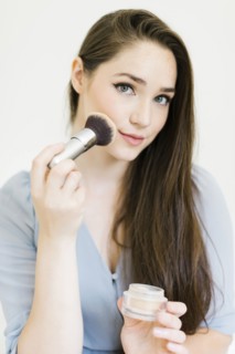 Woman applying make up with brush