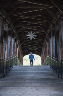 Man on covered bridge