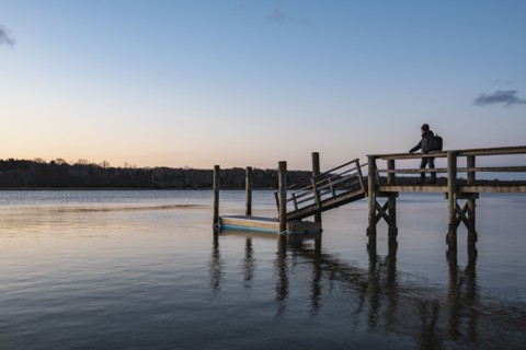 Silhouette of man on pier