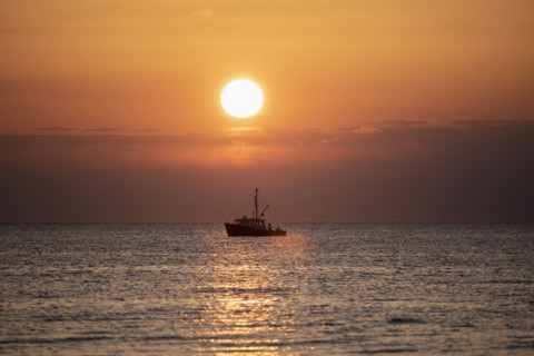 Fishing boat at sunset