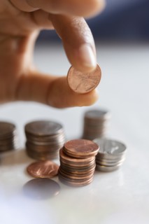 Hand of woman stacking coins