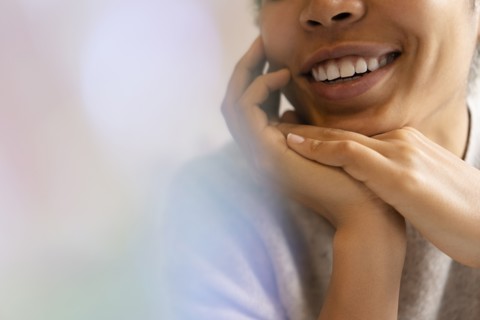Young woman with hands clasped