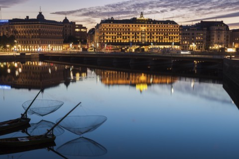 Buildings by river at sunset in Stockholm, Sweden
