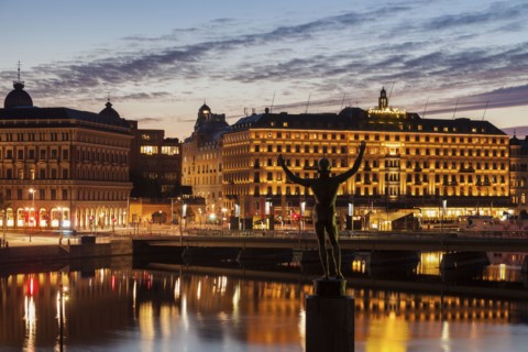 Statue by buildings at sunset in Stockholm, Sweden