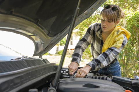 Woman repairing her car