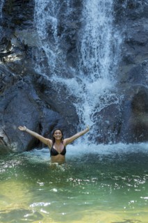 Woman by waterfall in Phuket, Thailand