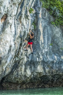 Woman rock climbing in Phuket, Thailand