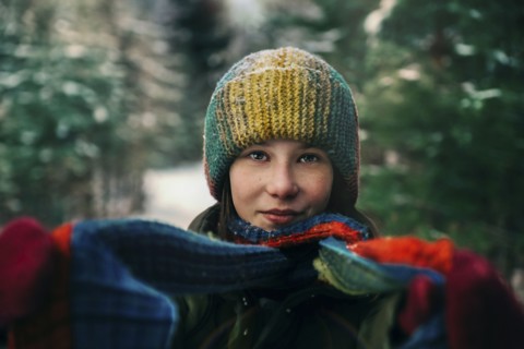 Teenage girl with colorful woollen hat and scarf during winter