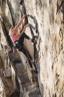 Teenage girl rock climbing