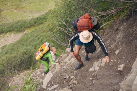 Hiking couple climbing hill