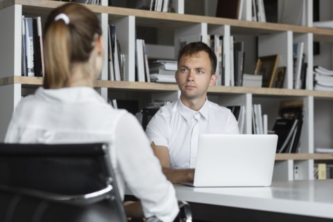 Businessman conducting job interview with young woman
