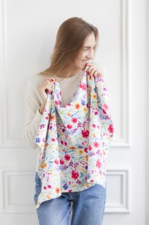 Smiling woman holding floral pattern fabric