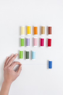 Woman's hand selecting thread