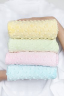 Hands of woman holding pastel color fabrics