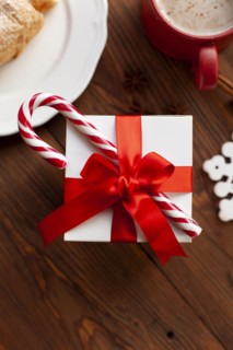 Christmas present with red ribbon and candy cane