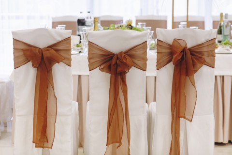 Ribbon tied to dining chairs at wedding