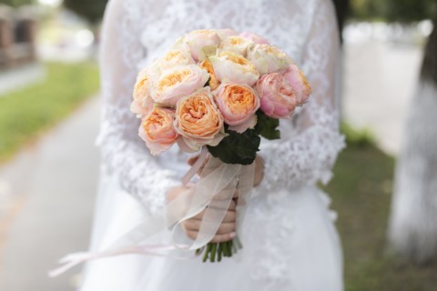 Hands of bride holding bouquet