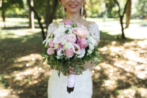Hands of bride holding bouquet