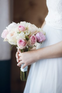 Hands of bride holding bouquet