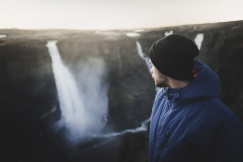 Hiker by Haifoss waterfall in Iceland