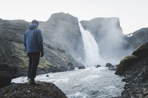 Hiker by Haifoss waterfall in Iceland