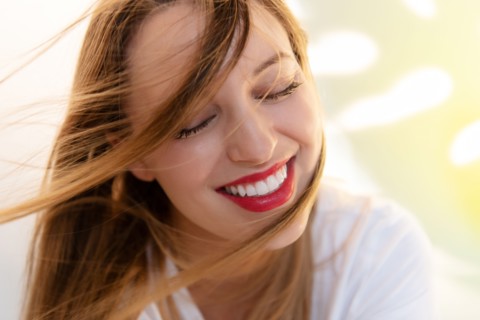 Portrait of windswept young woman wearing red lipstick
