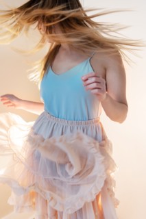 Young woman tossing her head while dancing