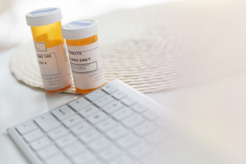 Pill bottles by computer keyboard
