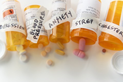 Spilled pill bottles labelled with ailments