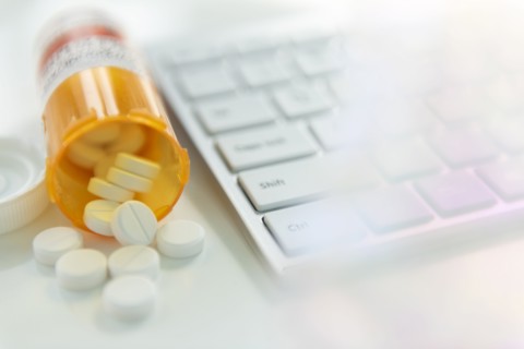 Spilled pill bottle by computer keyboard