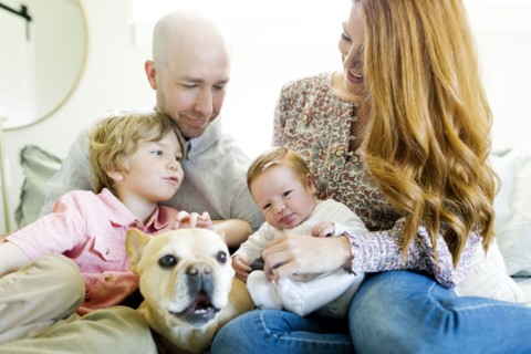 Family and their dog on bed