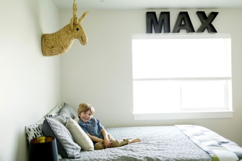 Boy sitting on his bed
