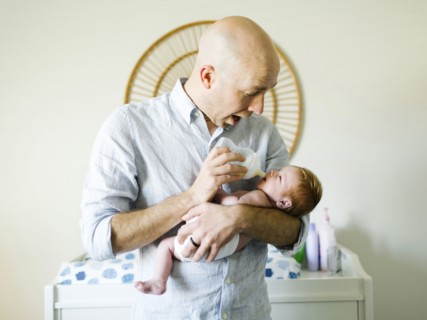 Man feeding his baby son