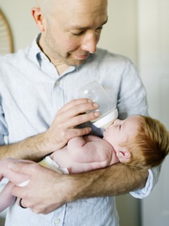 Man feeding his baby son