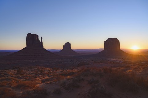 Silhouettes of rock formations at sunset in Monument Valley, Arizona, USA