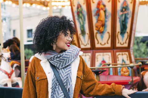 Young woman by carousel