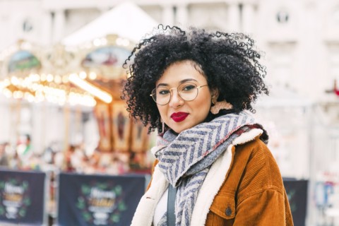 Portrait of young woman wearing glasses and red lipstick