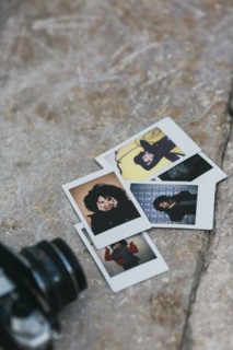 Polaroid photographs of young woman by camera