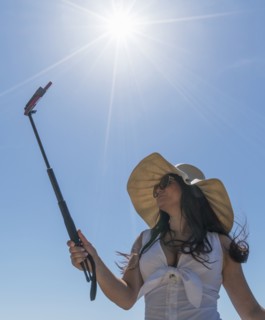 Low angle shot of woman using selfie stick