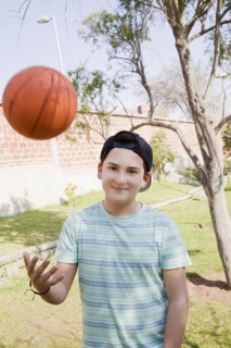 Teenage boy throwing basketball
