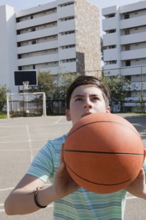 Teenage boy holding basketball