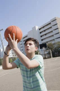 Teenage boy holding basketball