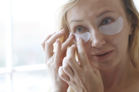 Woman applying under-eye mask
