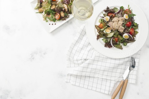 Plate of salad with white wine