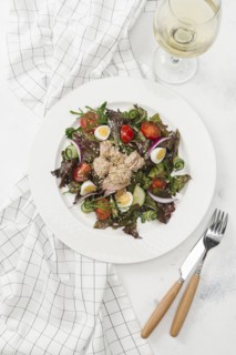 Plate of salad with white wine