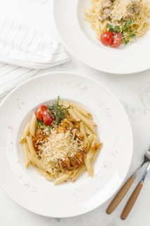 Bowl of pasta topped with cheese